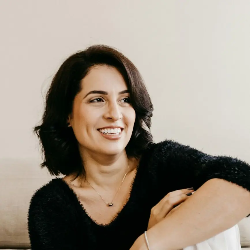 woman in black long sleeve shirt sitting on white couch